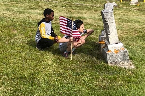 Students place flags in Biddeford cemetery